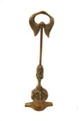 A Victorian brass door stop. Consisting of a ball and claw shape above a winged shaped handle.