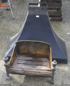 A vintage fire grate and chimney hood.