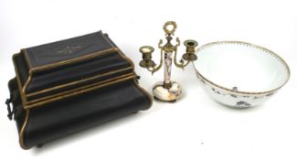 A porcelain bowl, a candlestick and a tin box.