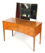 A mid-century Heals dressing table. With a set of six drawers, on square tapering supports.