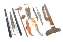 An assortment of tribal and ethnic vintage edged weapons.