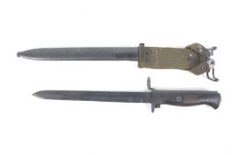 A WWII bayonet. Marked to handle 1345, the blade marked CE over WG, scabbard marked 19521.