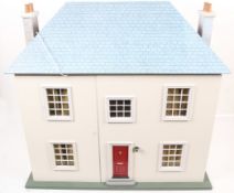 A modern dolls house in the style of a 1940s townhouse.