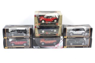 A collection of seven1:18 scale diecast Mini Coopers. From Burago and Maisto, all boxed.