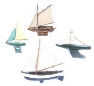A collection of four pond yachts. In a range of colours with cotton sails etc.