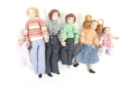 A collection of five vintage porcelin dolls. In a variety of outfits and poses.