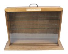A Dinky Toys wooden glass fronted display cabinet.