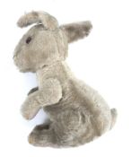 A circa 1950s Merrythought rabbit. A grey rabbit complete with whiskers.