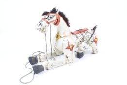 A wooden 'Muffin the Mule' Marionette puppet. Painted white with red bridle.