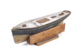 A wooden model pond yacht hull.