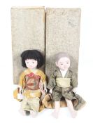A pair of early 20th century Japanese Ichimatsu oriental dolls, modelled as a man and a woman.