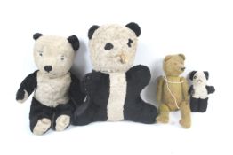 Four vintage teddy bears. Including three pandas and a teddy bear.
