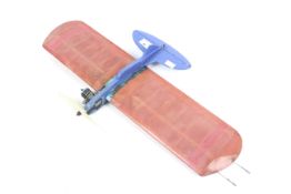 A small wooden single engined tether plane. Finished in blue with red trim.