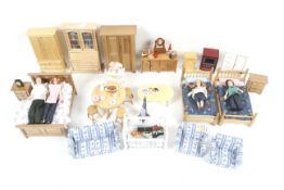 A collection of mainly pine dolls house furniture.