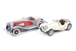 Two metal diecast cars. Featuring one Franklin Mint Jaguar SS.