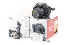 A Canon EOS 400D Digital SLR camera kit and two other digital cameras.