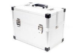 An Alliminium camera flight case. With hinged top section containing two smaller compartments.