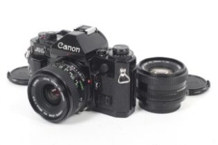 A Canon A1 35mm SLR camera outfit. With two lenses: Canon FD 50mm f1.8 and Canon FD 28mm f2.8.