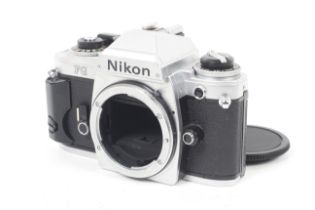 A Nikon FG 35mm SLR camera body. Chrome. Serial No. 8265153.