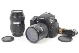An Olympus E3 Digital SLR camera outfit. With two lenses; an Olympus 14-55mm f2.8-3.