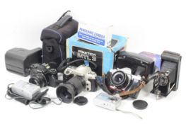 An assortment of cameras and photographic slides. To include a Nikon F60 with a 18-55mm f3.5-5.