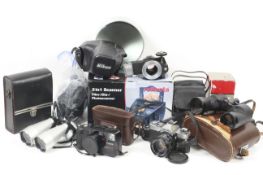 A large assortment of cameras, accessories and binoculars.