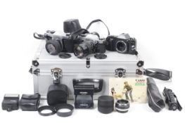 An assortment of cameras and accessories. To include a Canon AE1 Program with a Canon FD 135mm f2.