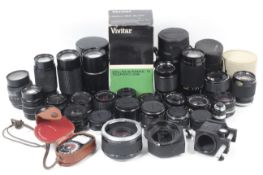 An assortment of camera lenses and len accessories.