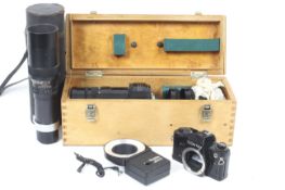 A Contax 35mm SLR camera body, two lenses and a flash.