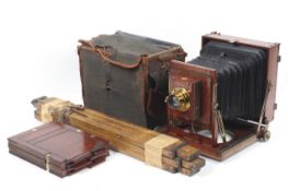 A Thornton Pickard mahogany and brass antique half plate camera. With a Taylor Taylor and Hobson 7.
