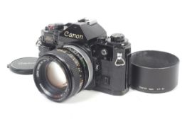 A Canon A1 35mm SLR camera. Black. Serial No 360773. With a Canon FD 50mm f1.4 S.S.C.