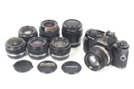 An Olympus OM-4Ti 35mm SLR camera outfit. With six lenses; an Olympus OM 16mm f3.
