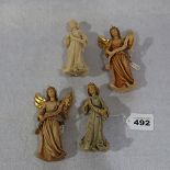 4 Holzfiguren 'Engel', 3 davon farbig gefaßt, H 13 cm