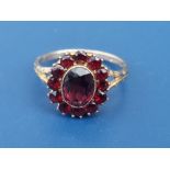 A Bohemian garnet set oval 9ct cluster ring. Finger size K.