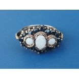 An opal & sapphire set cluster style 9ct gold ring, having three central opals, London marks. Finger