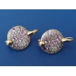 A pair of modern pink & white diamond set 18ct gold earrings, each formed as a disc pave set with