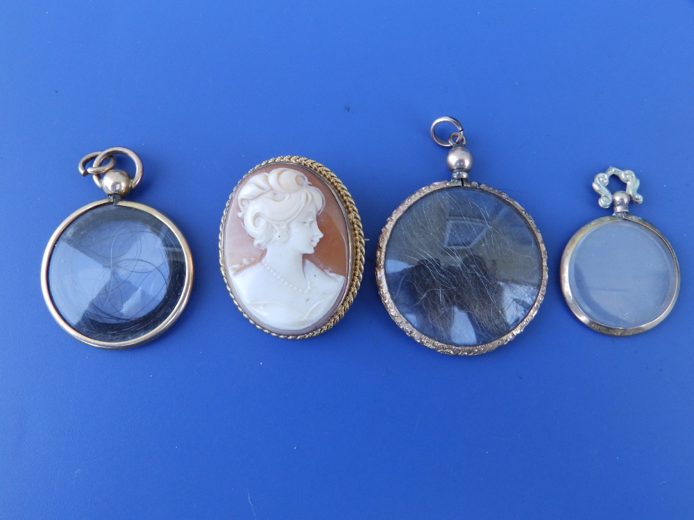 A 9ct cameo brooch/pendant, 1.3" and three circular glazed lockets. (4)