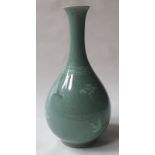 A Korean celadon glazed biottle vase decorated with a small crane & floral sprigs, 7.5" high.
