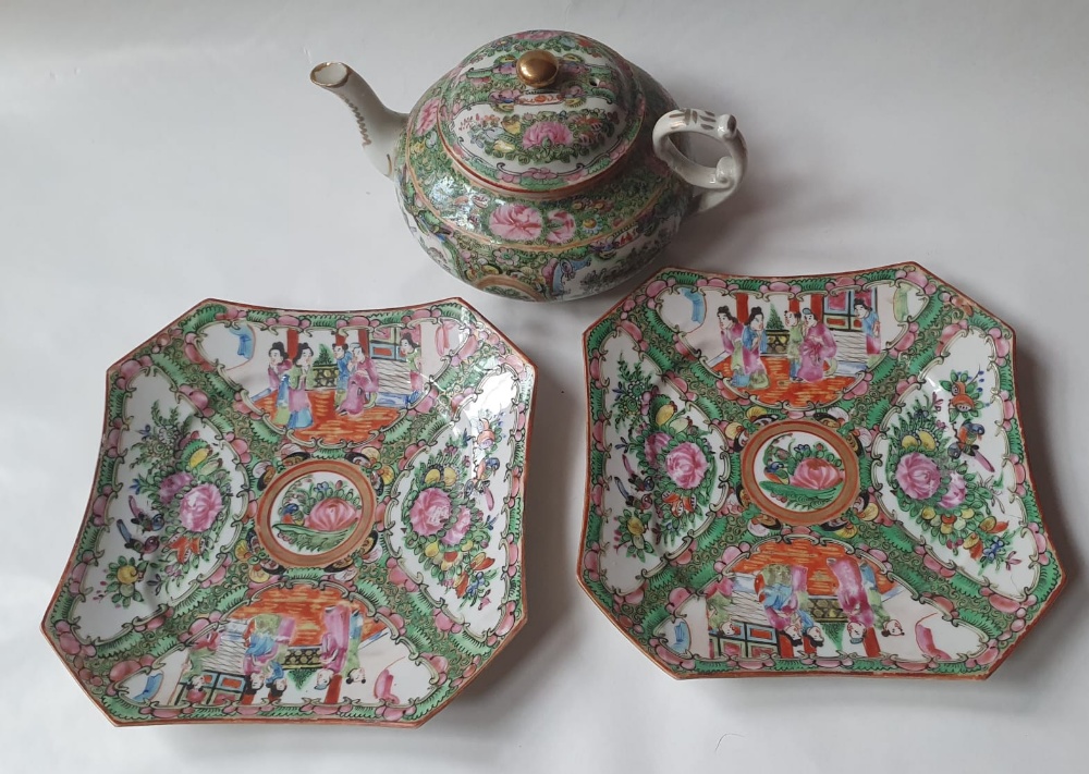 A Chinese famille rose Canton porcelain teapot and two plates, the teapot 9" high. (3)