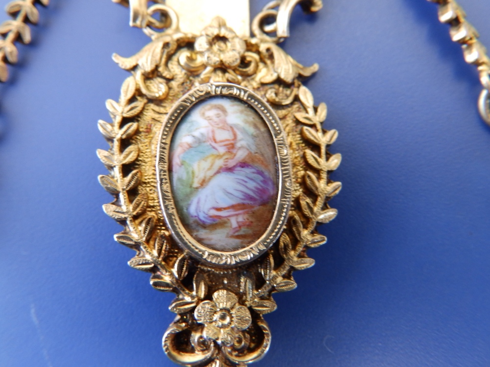 A gilt metal chatelaine in the 18thC style, set with two enamel painted porcelain figural plaques, - Image 3 of 4