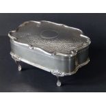 An art nouveau silver jewellery box, the shaped hinged cover having a central vacant circular