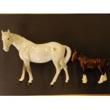 A Beswick grey mare facing left and a brown shire foal. (2)