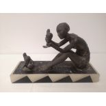 A French art deco metal figure study of a seated flapper with three doves, on black & white onyx
