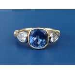A Theo Fennell three stone sapphire & diamond set 18ct gold ring, the central collet set sapphire
