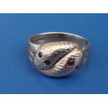 A 9ct gold band ring formed as two serpents with ruby/garnet eyes - Birmingham marks. Finger size