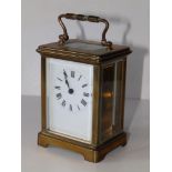 A French brass carriage clock, 4.5" high excluding handle.