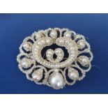 A Victorian certified natural saltwater pearl brooch, of oval openwork form, set with threaded
