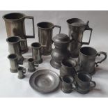 A collection of pewter, including measures and tankards, the largest measure 7" high.
