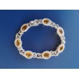 A modern Italian 18ct white gold bracelet comprising seven yellow sapphire & diamond clusters united