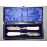 A cased pair of mother-of-pearl handled silver butter knives. (2)